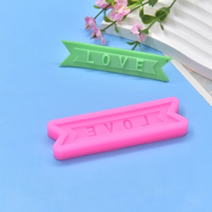 Pink silicone mold for DIY banner shaped soap or fondant with LOVE letters texture