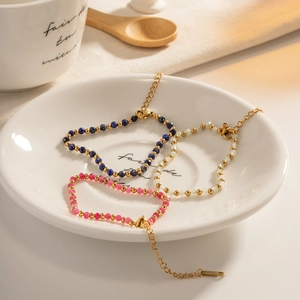 Colorful beaded steel bracelets in blue and pink with gold lobster clasp and extension chain