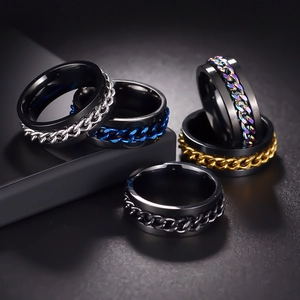 Men's rotatable stainless steel chain rings in five diverse colors on black pedestals