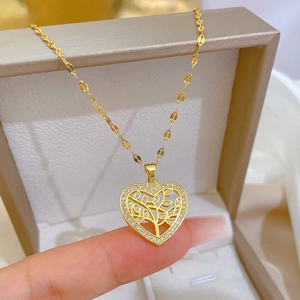 Titanium gold heart necklace with tree of life pendant and small crystal accents