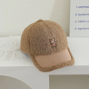 Detailed view of the embroidered teddy bear on a warm brown fleece baseball cap