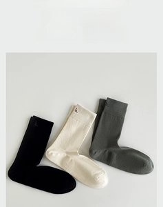 Detail of three-color 90-degree heel cotton socks featuring high elastic ribbed cuffs