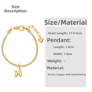 Detail view of 18K gold plated H-letter charm bracelet with cubic zirconia and heart clasp