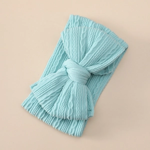Detailed texture of light blue knitted baby headband with a large double layer bow