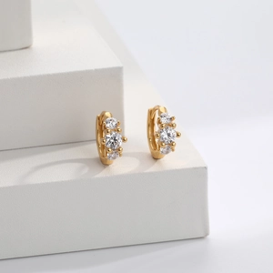 Elegant gold S925 sterling silver huggie earrings with three sparkling zircon stones