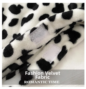 Detail of soft faux fur cow print fabric with functional white hook-and-loop fasteners