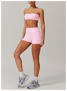 Pink athletic two-piece yoga set with crop top and high-waisted gym shorts