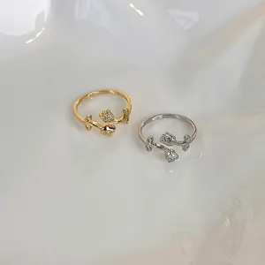 Elegant tulip ring with micro-set zircons in gold and silver, minimalist open design