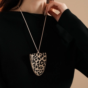 Detail of leopard print faux leather pouch necklace worn as a stylish accessory