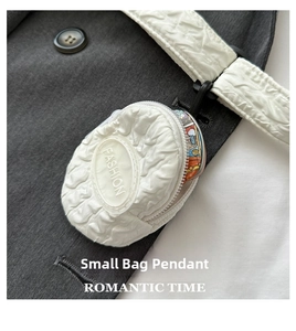 Detail shot of a white ruffled coin purse with Fashion logo and metal hanging hook