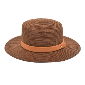 Detail of dark brown straw hat weave with orange leather band and gold metal stud