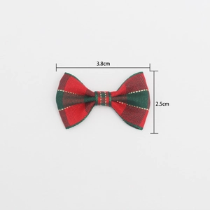 Macro shot of 3.8cm red and green plaid mini bow with gold thread and size labels