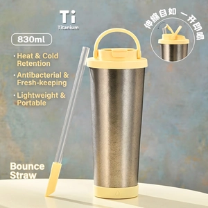 Detailed macro view of 830ml pure titanium bottle with yellow lid and pop-up straw