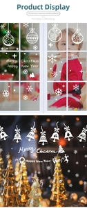 Detailed view of white Christmas window stickers with snowflakes and reindeer bells