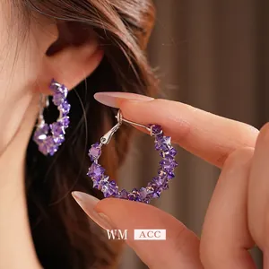 Luxury hoop earrings with faceted purple crystals in a vintage sterling silver finish