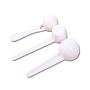 Set of three white plastic measuring spoons with long handles for kitchen powder measurement