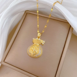 Detail of gold money bag necklace with crystal stones and unique dollar symbol design