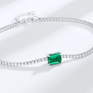 Elegant S925 silver tennis bracelet with emerald-cut green stone and sparkling white zircons