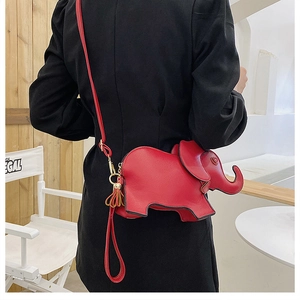 Detailed view of a red elephant-shaped PU leather crossbody bag with tassels and strap