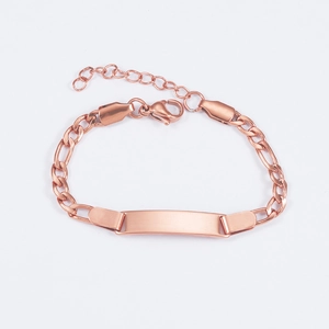 Detailed macro view of a rose gold kid's Figaro chain bracelet with a blank engravable bar