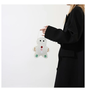 Detail of creative gingerbread man felt tote bag with festive embroidery and soft texture