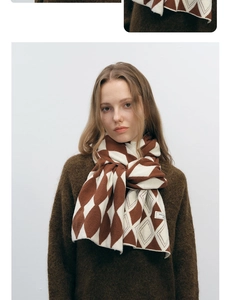 Detail of soft brown and beige diamond pattern knit scarf with textured warm fabric