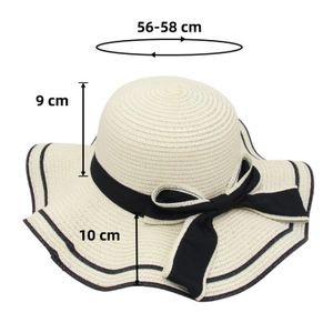 Detail of a straw sun hat featuring a 10cm wide brim and a black ribbon bow decoration