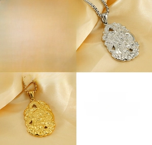 Detailed macro view of 18K gold-plated double-sided dragon relief pendant on stainless steel