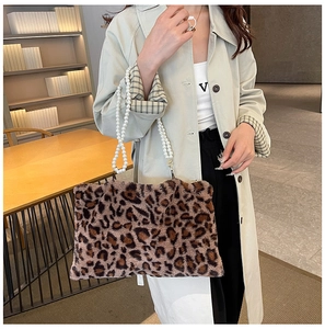 Detail of leopard print faux fur handbag with dual imitation pearl handle chains