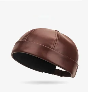 Detail of dark brown PU leather docker hat with adjustable strap and stitching