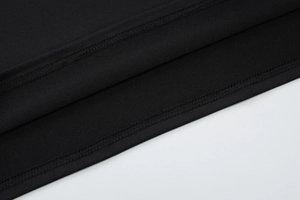Detail of the high-quality double-needle stitching and fabric texture on a black dress
