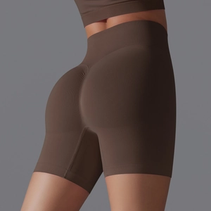 Macro shot of high-waist seamless scrunch butt yoga shorts in dark chocolate brown finish