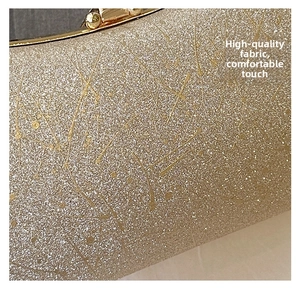Detail of shimmering gold fabric texture with metallic finish for luxury evening clutch bag