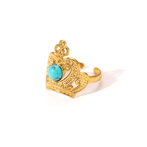 Detailed close-up of golden crown titanium steel ring with a turquoise stone inlay