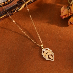 Detailed close-up of a golden leaf pendant with marquise opals and zircon accents