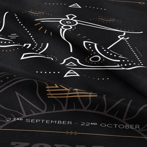 Macro detail of Libra zodiac tapestry featuring golden constellation on black woven fabric