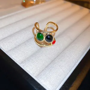 Golden dragon-themed open ring featuring three colorful layered round gemstones