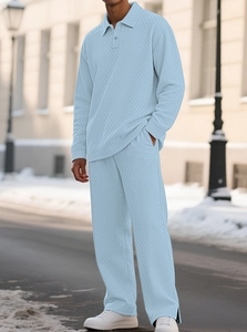 Detail of light blue men's polo set featuring distinctive diamond knit texture and polo collar