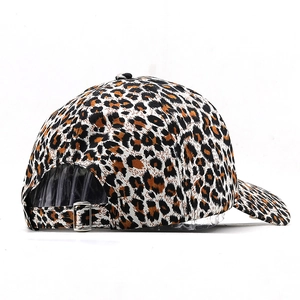 Close-up of leopard print baseball cap featuring an adjustable metal buckle at the back