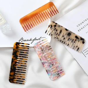 Detail of four wide-tooth acetate hair combs with marble and tortoiseshell patterns