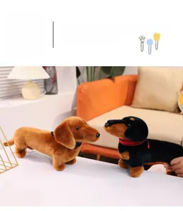 Detail view of two plush dachshund dogs in brown and black colors on a cozy orange sofa