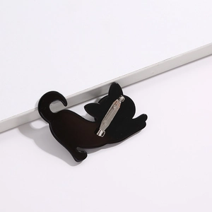 Black acrylic cat brooch accessory featuring a sturdy metal safety pin on a white background
