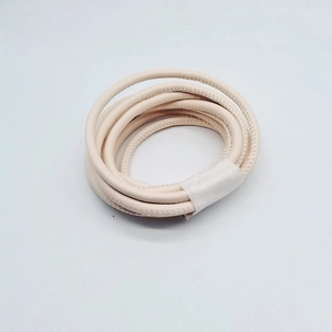 Macro detail of 6mm off-white leather cord showing fine texture and stitched edges for DIY