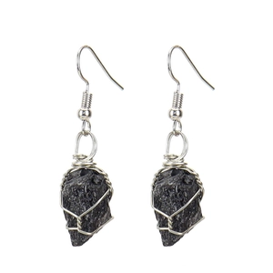 Detailed macro of handmade wire wrapped natural black tourmaline stone drop earrings