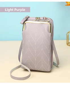 Detail of light purple leather phone bag featuring wavy quilting and gold metal clasps
