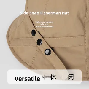 Detail of khaki sun hat featuring side snap buttons and wrinkle-resistant fabric texture