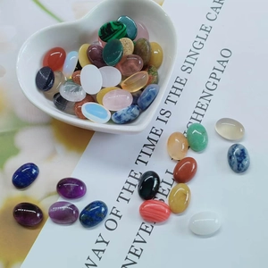 Oval natural stone cabochons in a white heart bowl for DIY jewelry making