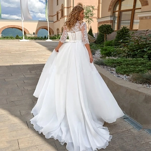 Robe de mariée blanche élégante avec col en V, manches en dentelle et longue traîne