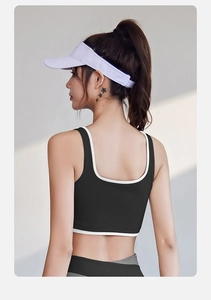 U-shaped back design of high-impact black sports bra with white contrast trim detailing