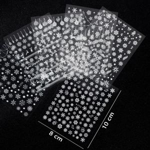 Laser white Christmas nail art stickers featuring snowflakes, reindeer, and Santa patterns